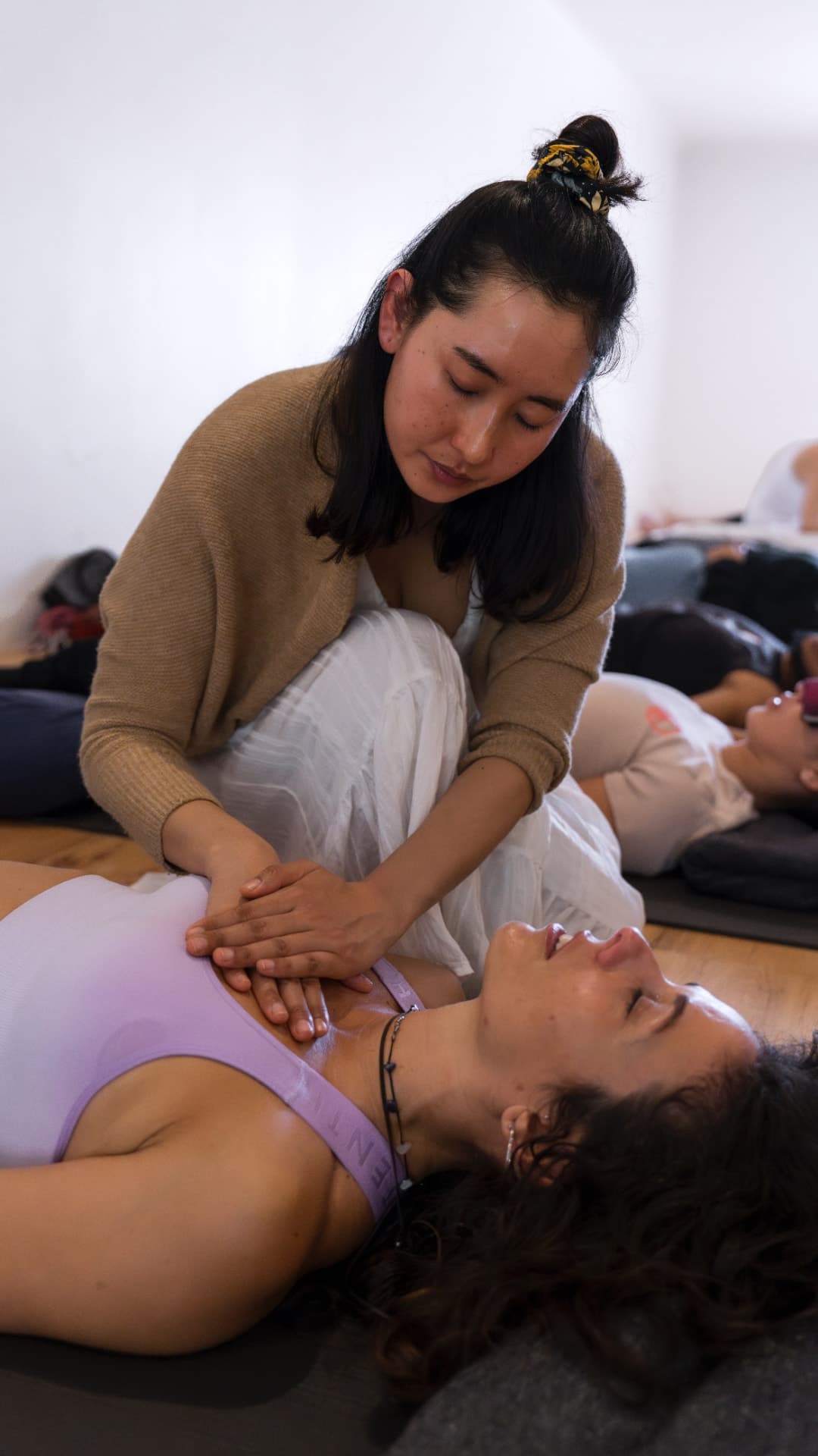 Tshering placing her hands on a client during an energy healing session
