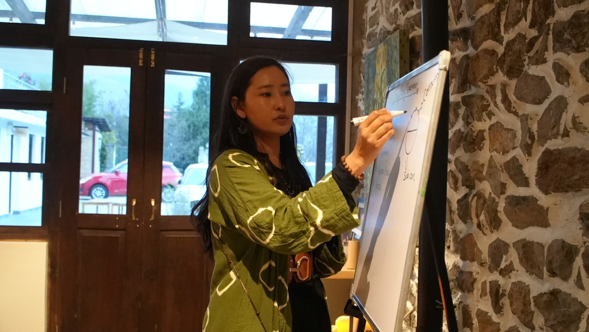 Tshering teaching with a whiteboard during a session