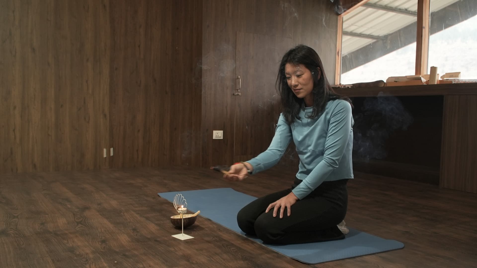 Jigme lighting incense before practice