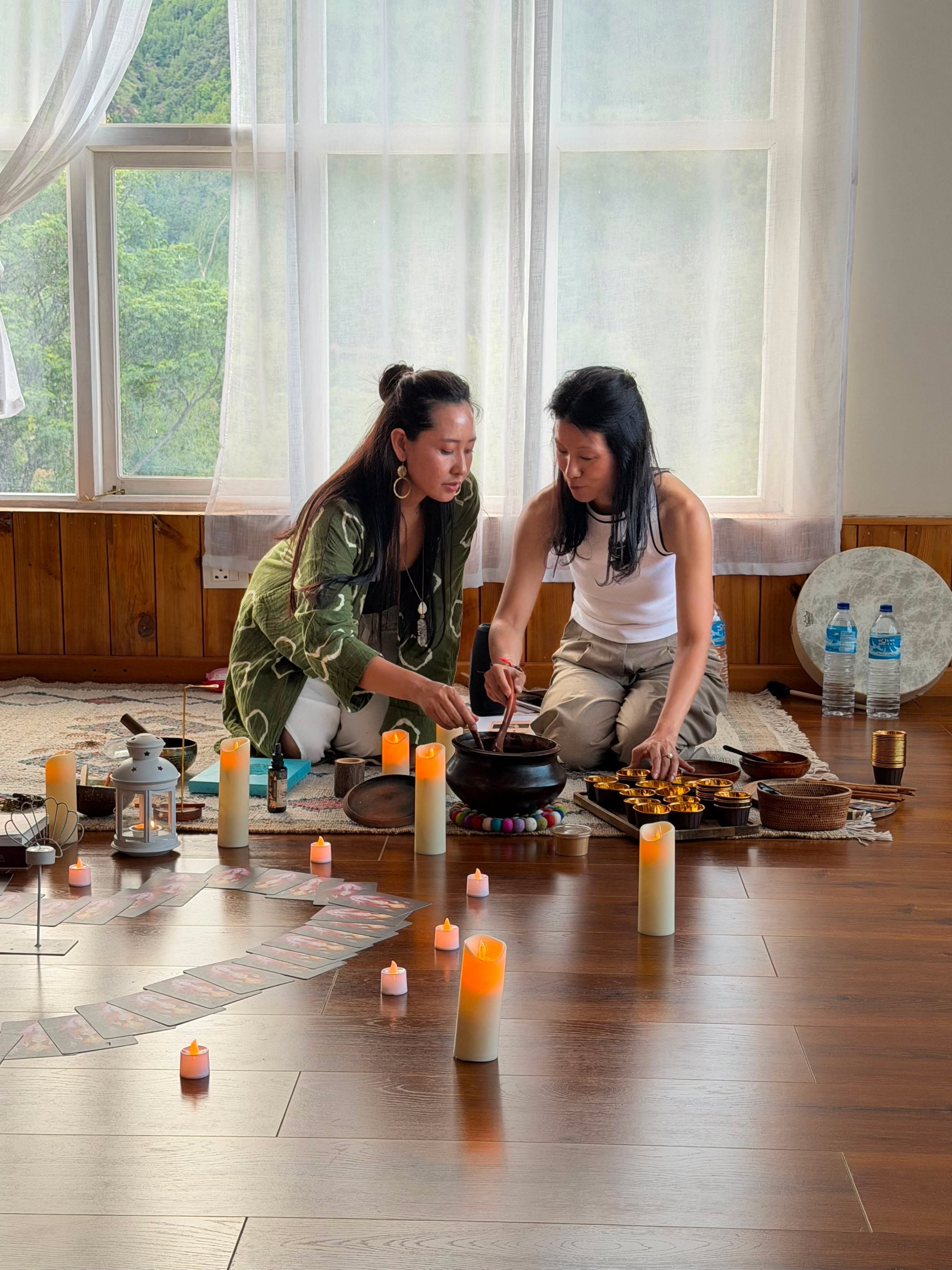 Tshering and Jigme preparing an altar with candles and singing bowls