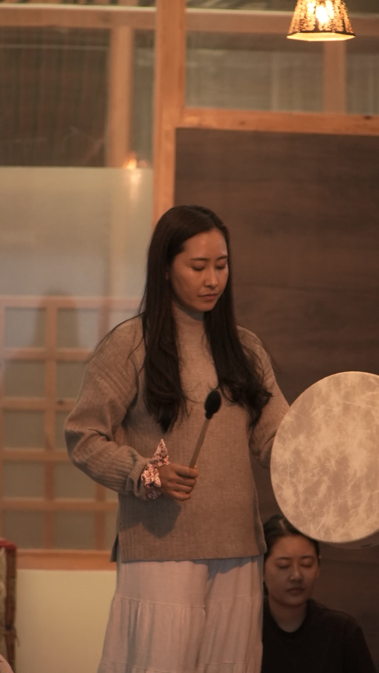 Tshering leading a drum journey during a sound healing session